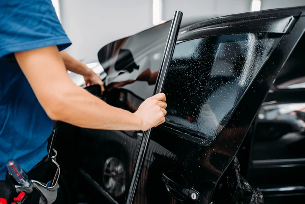 male-specialist-applying-car-tinting-600nw-744143530
